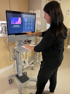 Staff member demonstrates how the new telehealth unit looks